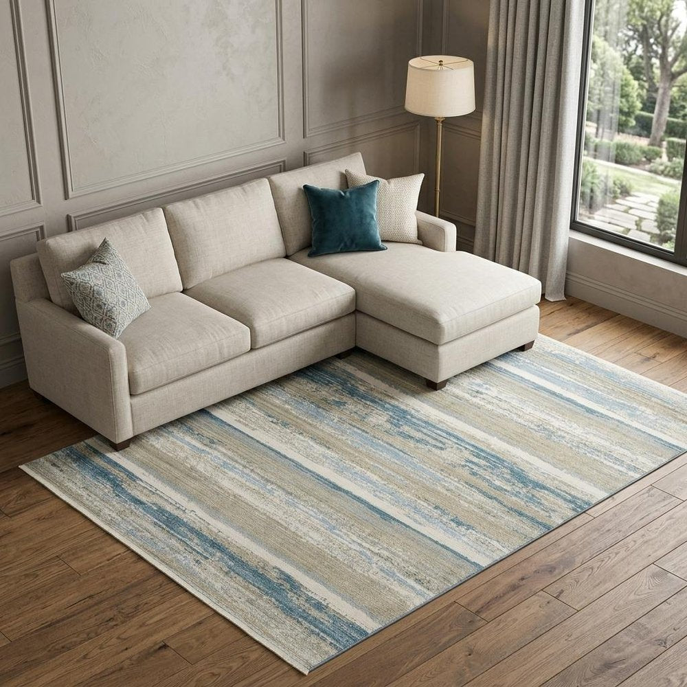 8' X 11' Ivory Beige Grey Blue And Tan Abstract Power Loom Stain Resistant Area Rug With Fringe