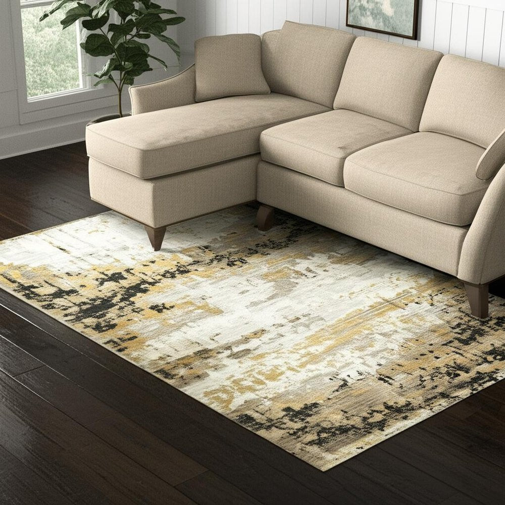 5' X 8' Grey Gold Black Charcoal And Beige Abstract Power Loom Stain Resistant Area Rug With Fringe