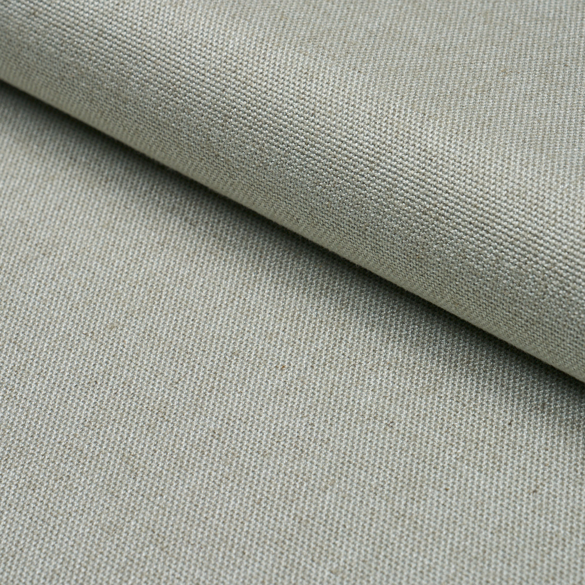 Close-up of light gray linen-look fabric with tight weave, rolled edge, soft drape, rustic textile.