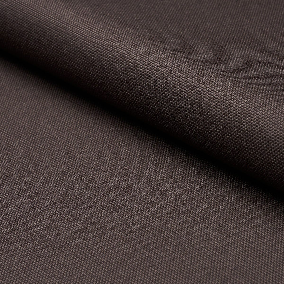 Dark brown woven fabric close-up showing tight texture and diagonal weave.