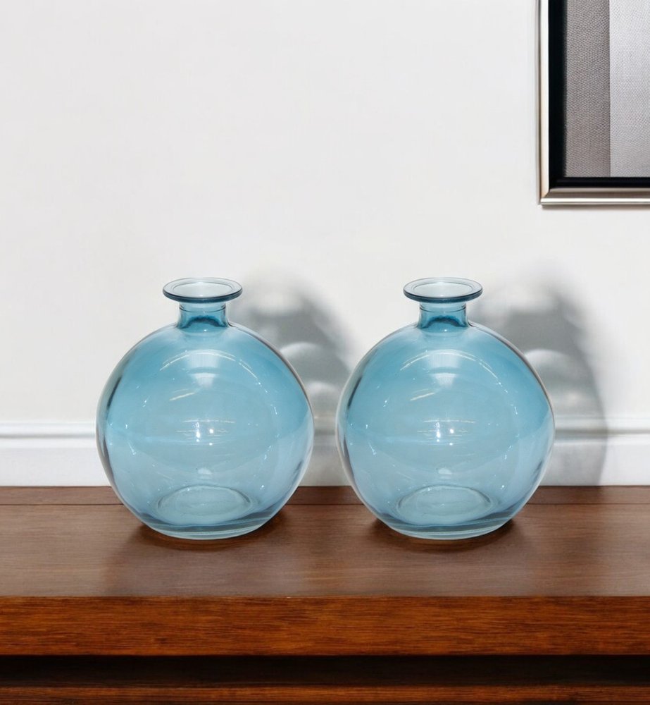 Two blue glass round table vases