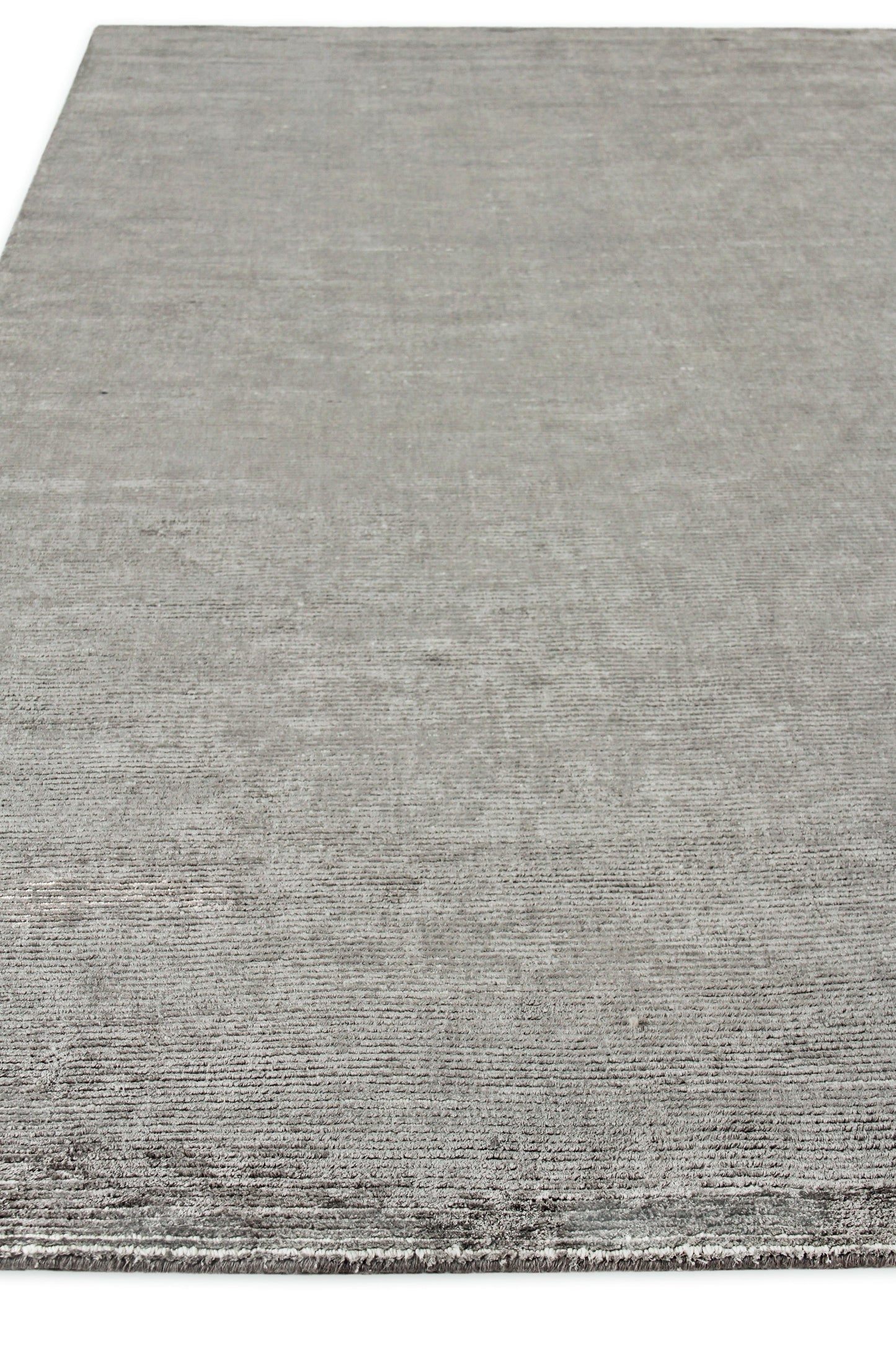 Rectangular gray rug with subtle ribbed texture and short fringe along the edge.