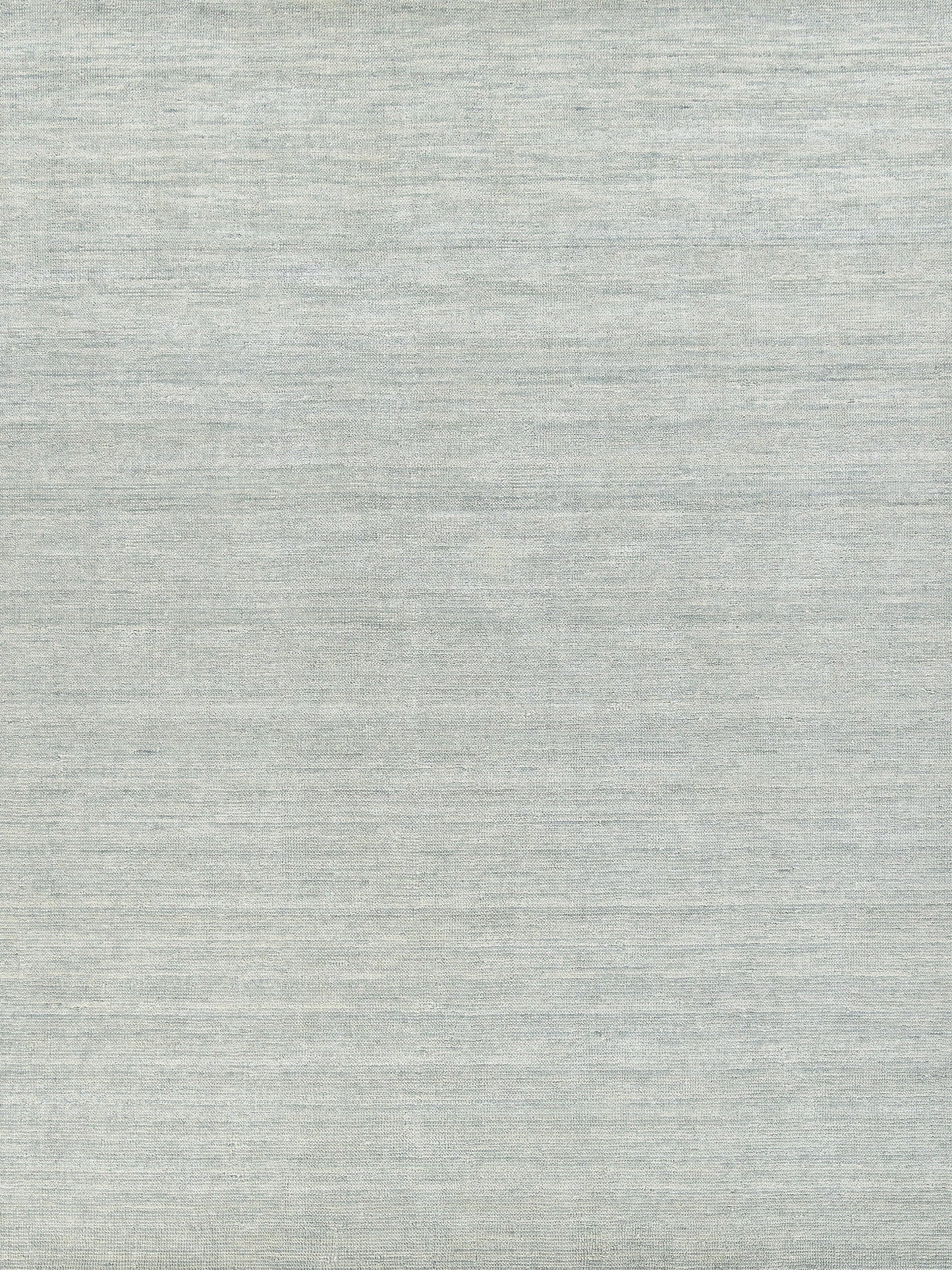 Light gray heather rug with subtle woven grain; handloomed rectangle.