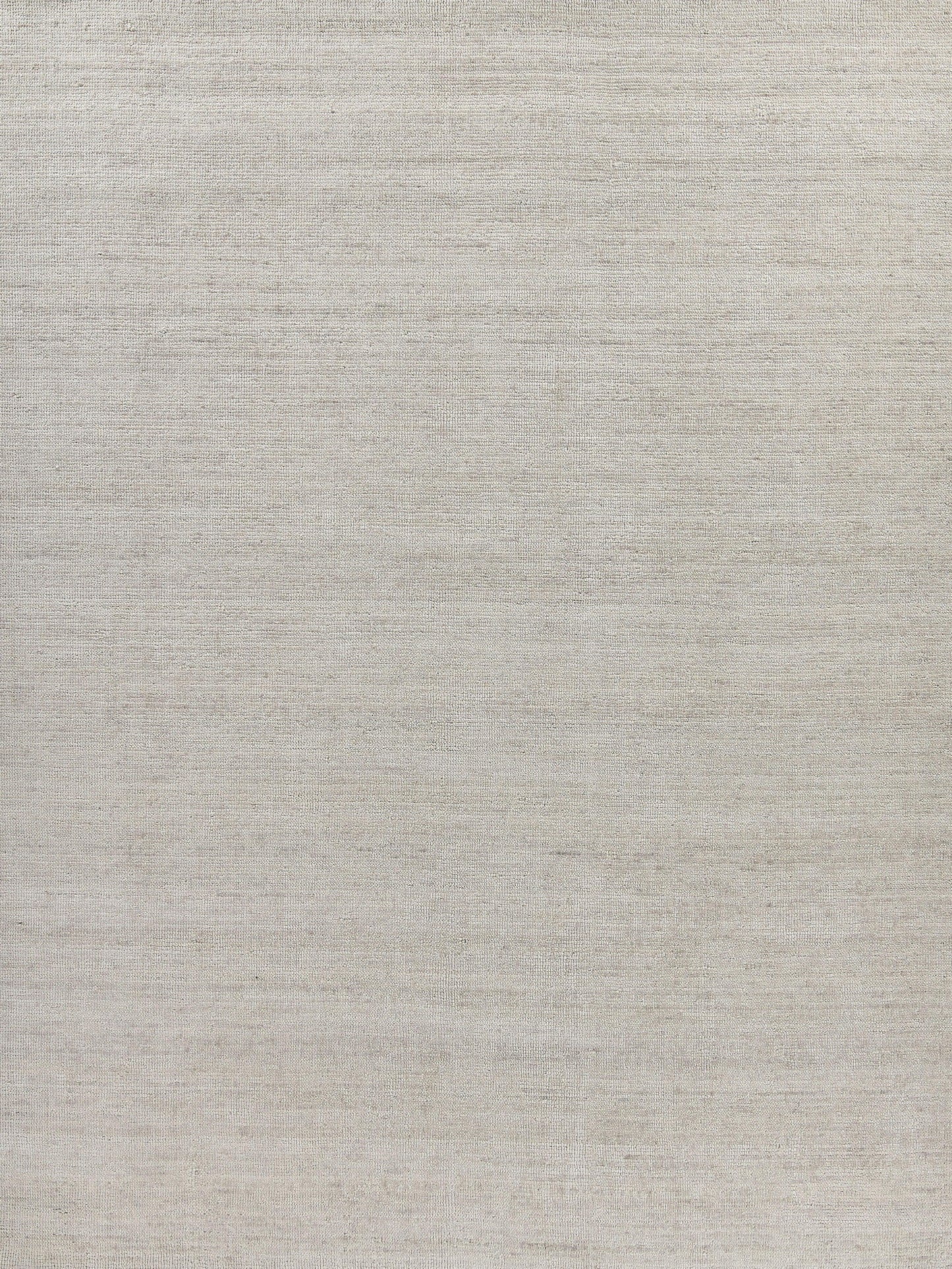 Beige linen-like woven rug with subtle gray undertones; hand-loomed.