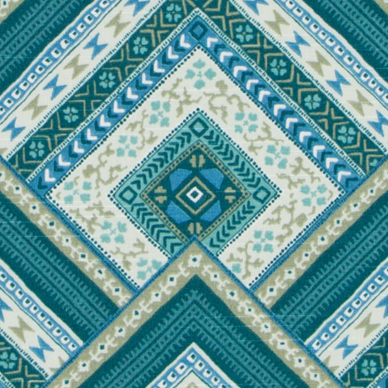 Teal, blue and beige geometric diamond pattern textile with layered square motifs for decorative throws or upholstery.
