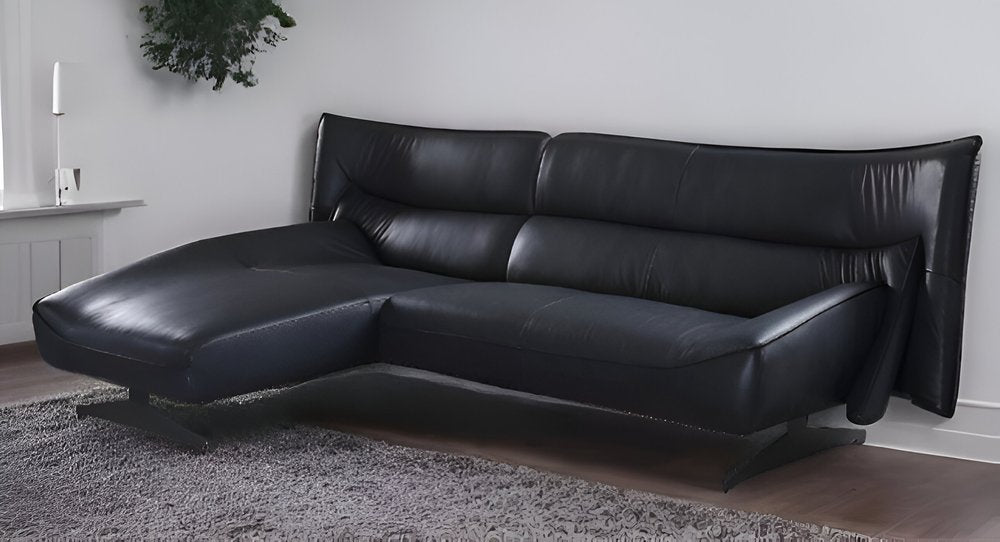 Black leather L-shaped sectional sofa with chaise, modern low-profile design on metal legs.