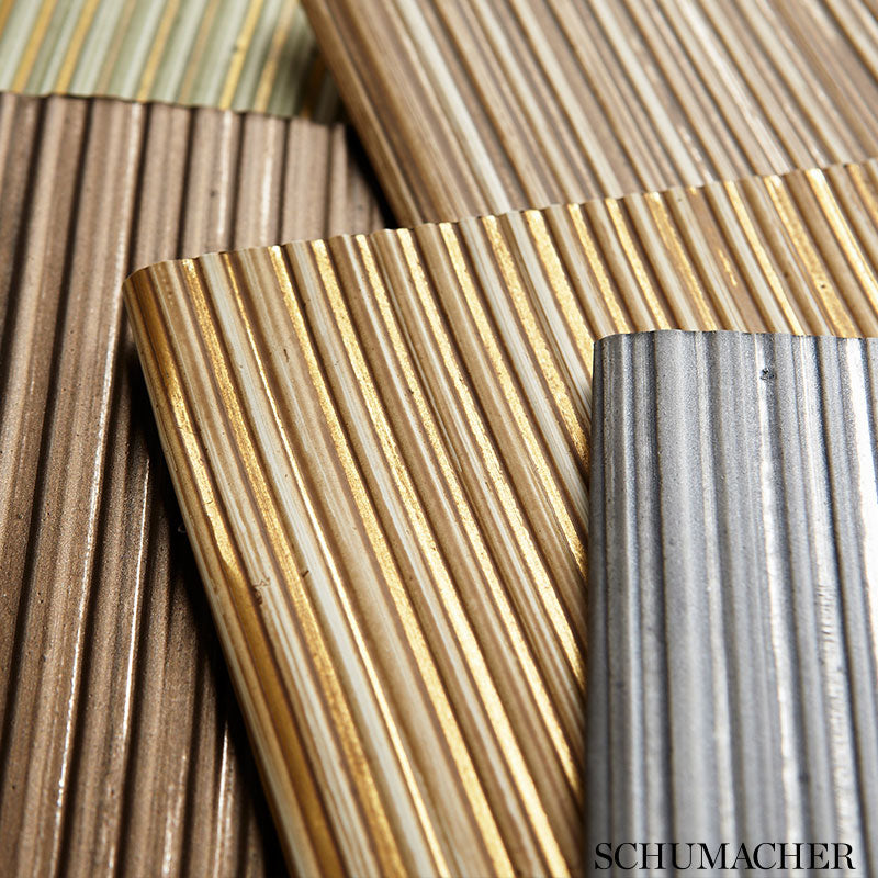Assorted metal corrugated sheets in bronze, gold, copper and gray with ribbed texture for roofing/cladding.