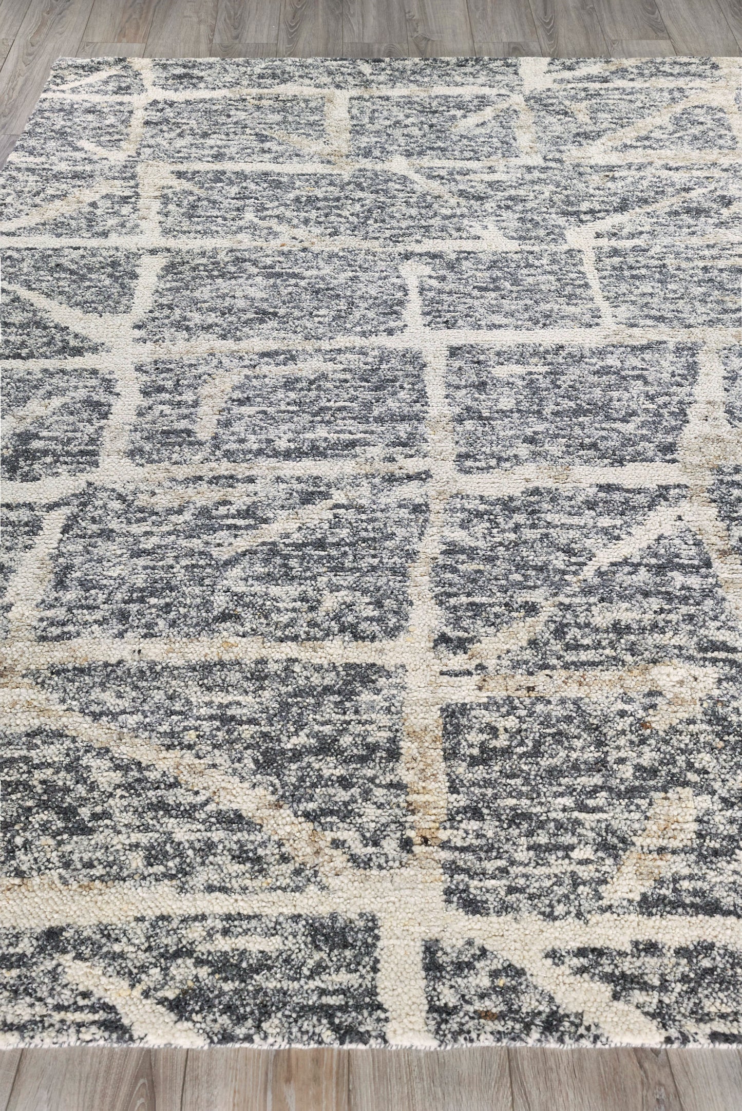 Rectangular gray rug with cream lattice grid pattern; plush textured pile for modern living spaces.