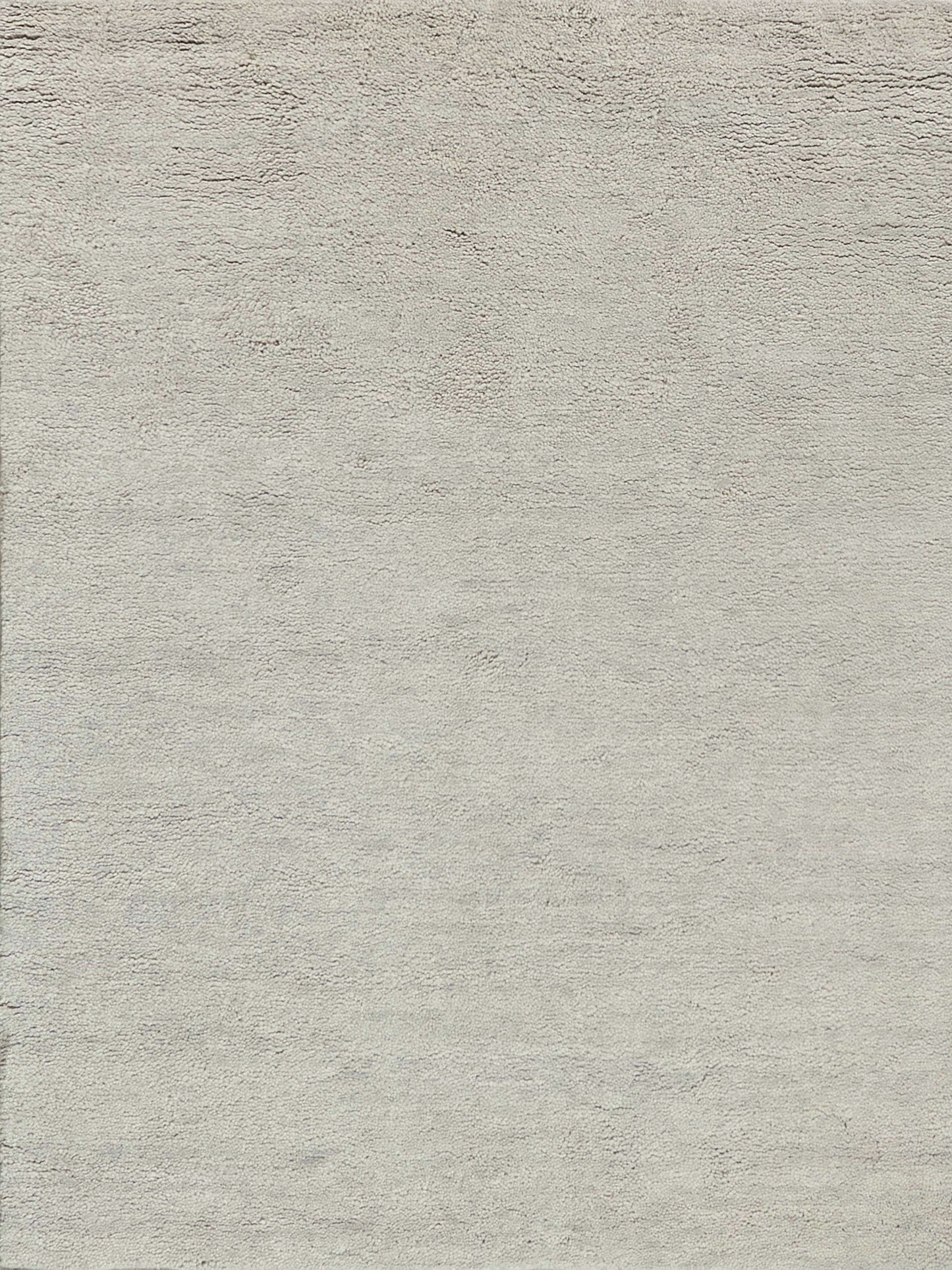 Beige hand-knotted rug with a soft, textured surface and subtle gray undertones.