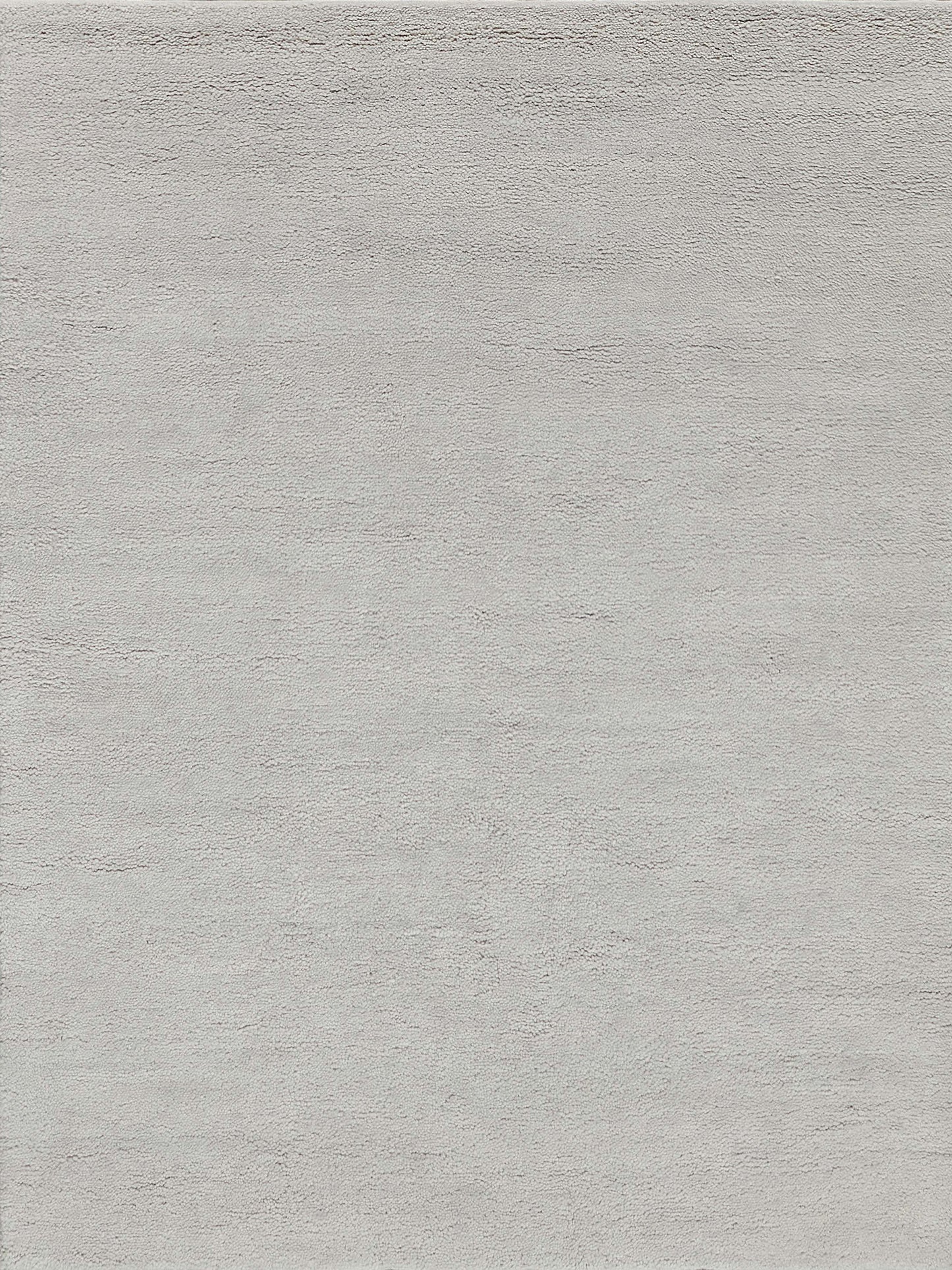 Light grey textured rug with soft plush pile and subtle tonal shading.