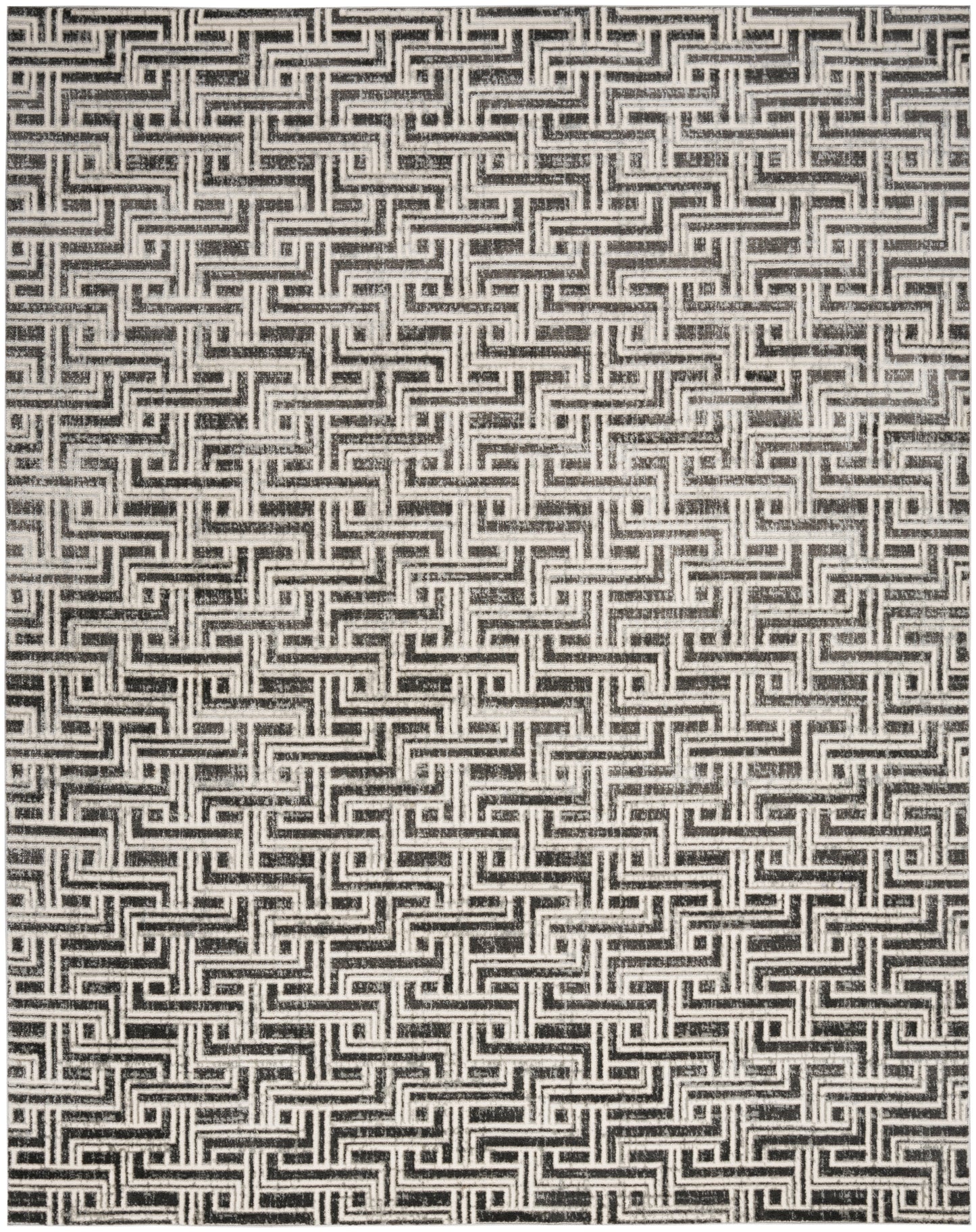 Black and white woven rug with a repeating Greek key maze pattern; bold geometric texture.