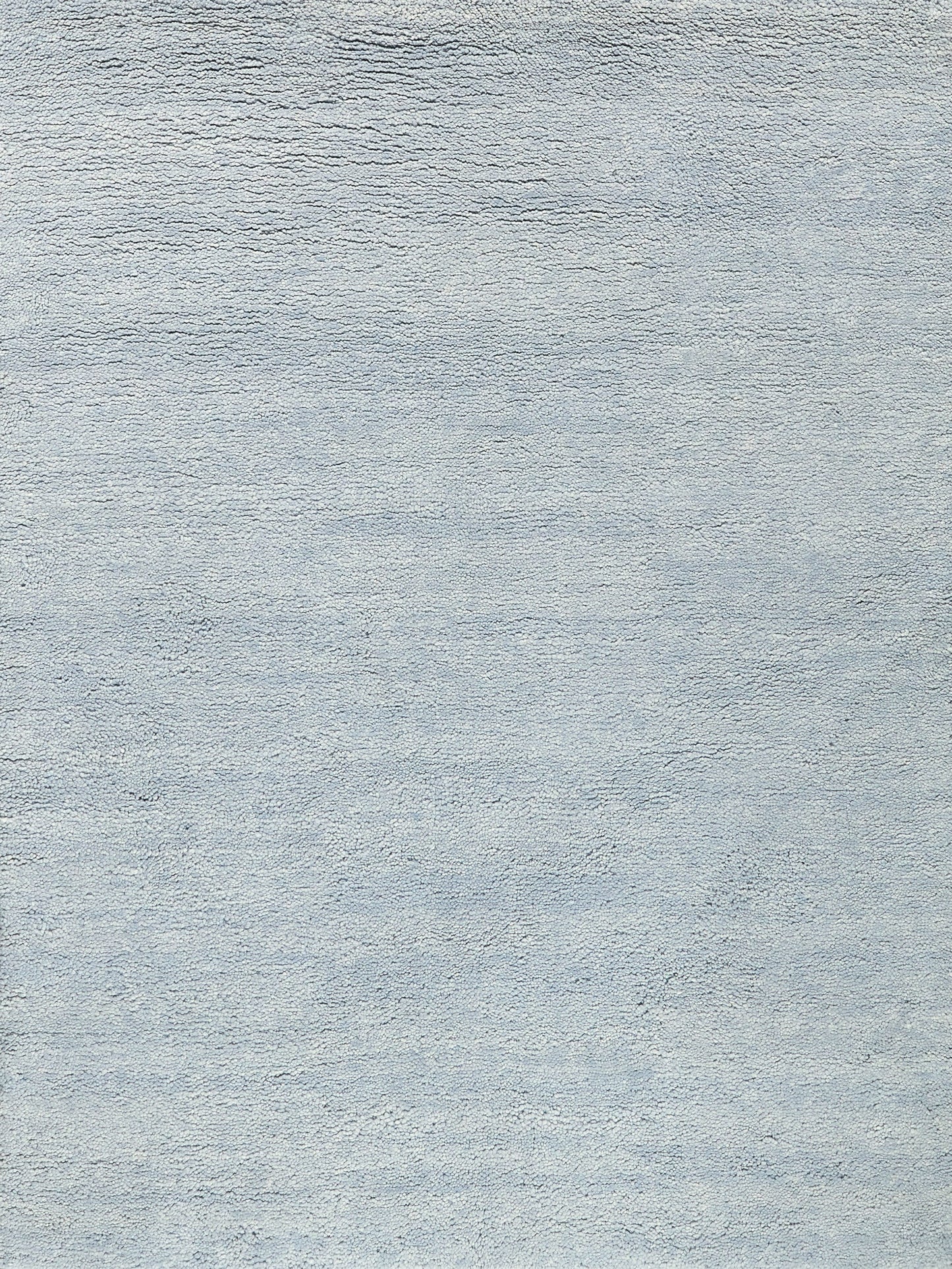 Blue-gray textured rug with a soft woven surface, neutral decor for living room or bedroom.