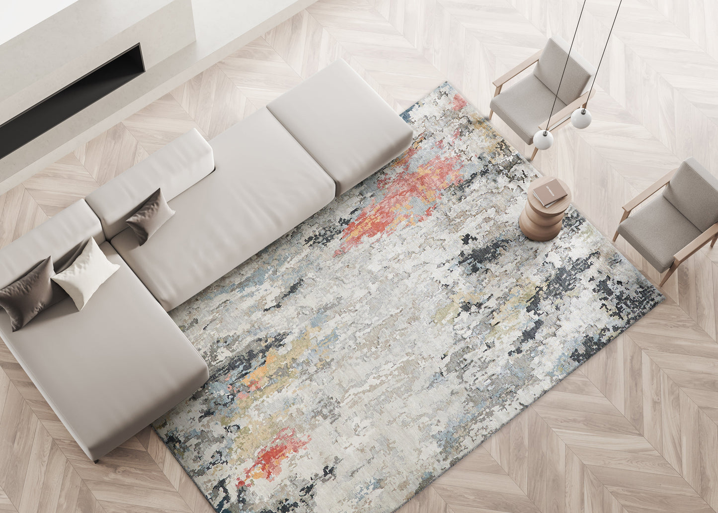 Living room with a light gray sectional sofa, beige pillows, and a multicolor abstract area rug on a herringbone wood floor.