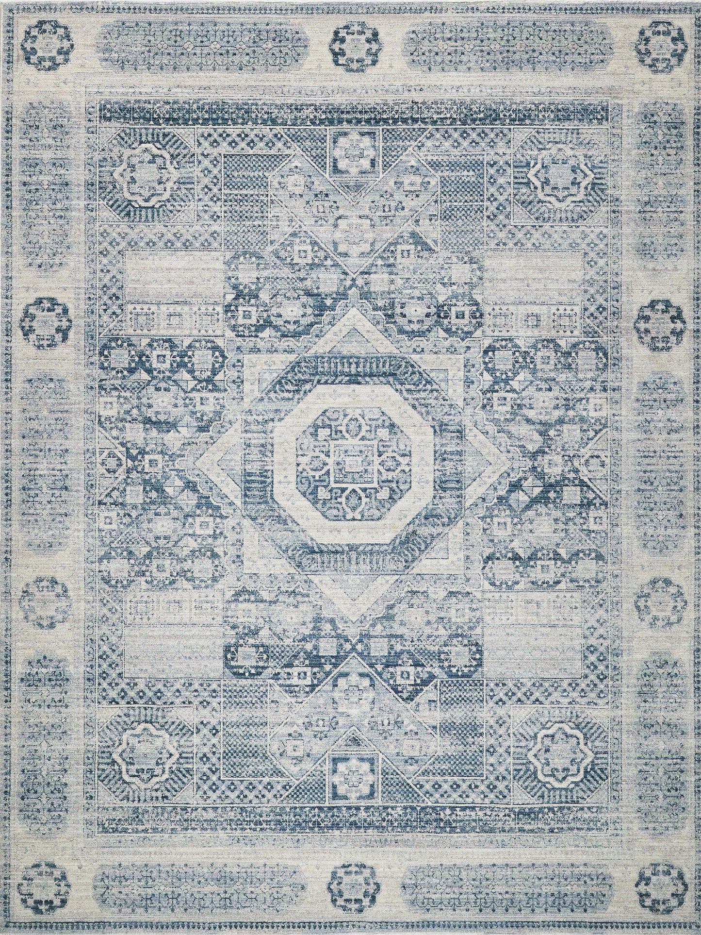 Distressed blue and ivory oriental rug with intricate geometric medallion center and ornate border.