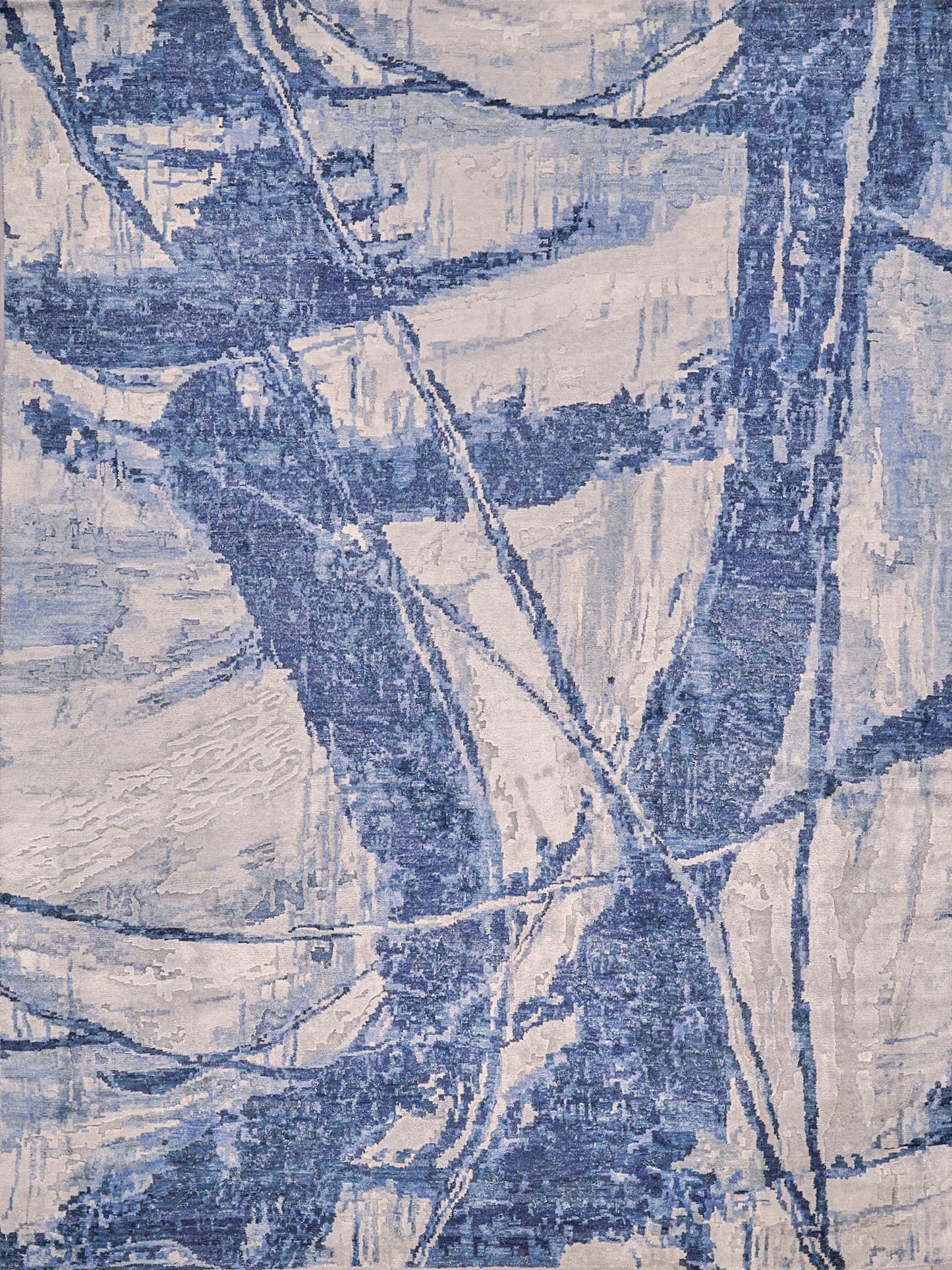 Abstract blue and beige area rug featuring smooth, flowing lines and textured patterns, perfect for modern home decor.