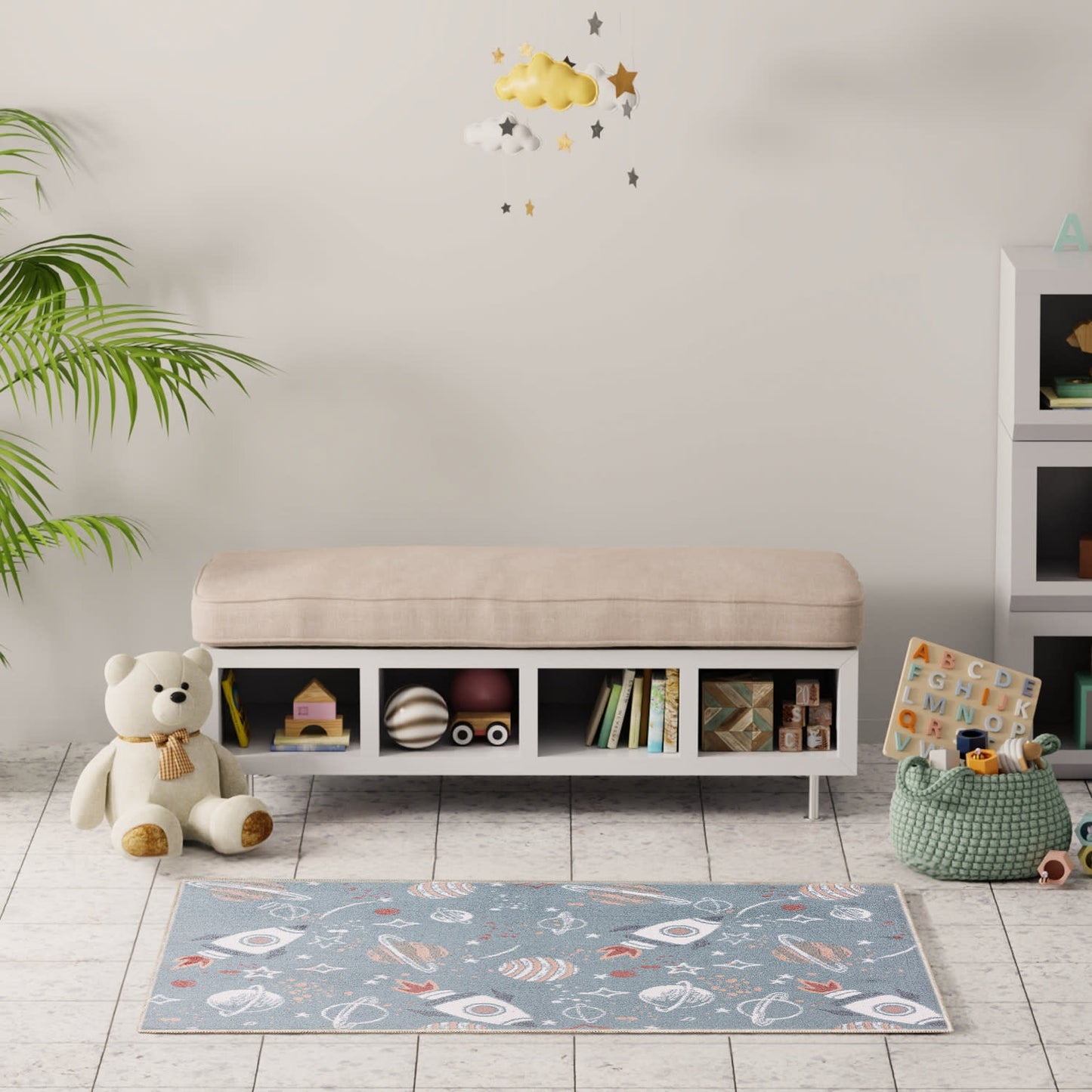 Cozy playroom with a beige cushioned bench, white cubby storage, teddy bear, blue space-pattern rug, and a plant.