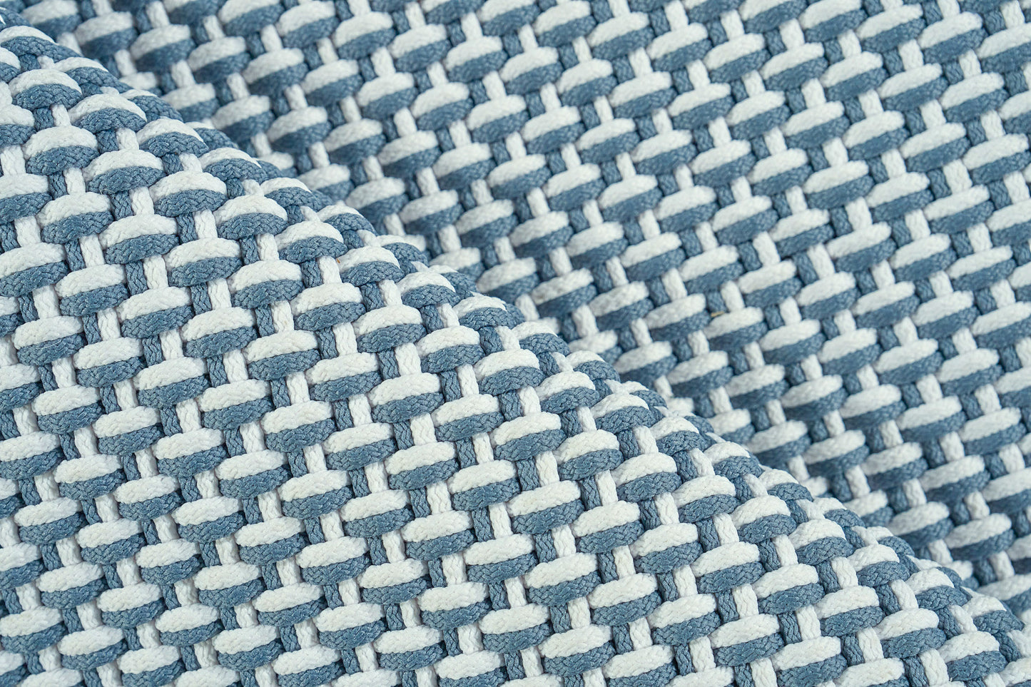 Close-up of blue & light blue woven rug with a chunky basketweave texture.