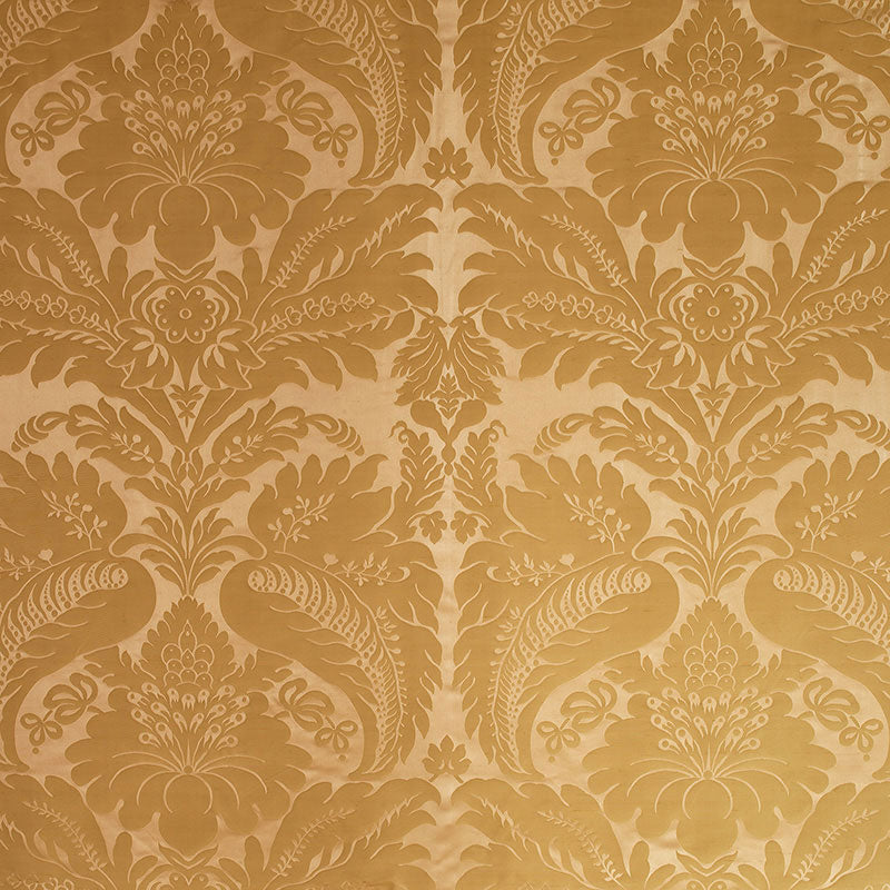 Golden damask wallpaper with ornate floral and peacock motifs in a symmetrical vintage pattern.