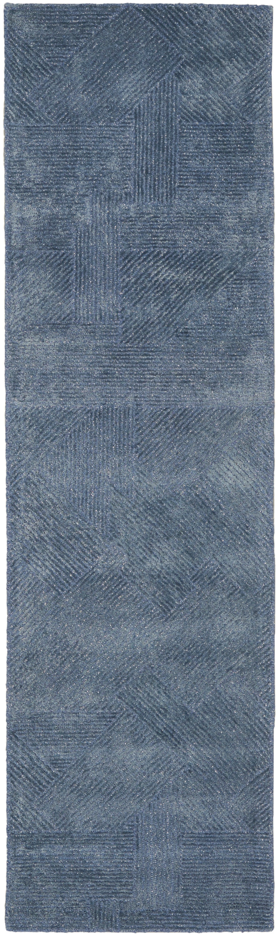 Blue patchwork rug runner with textured squares and diagonal line patterns, soft brushed surface.