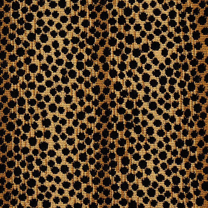 Gold leopard print velvet fabric texture with black spots; luxurious animal-print pattern for dresses or accessories.