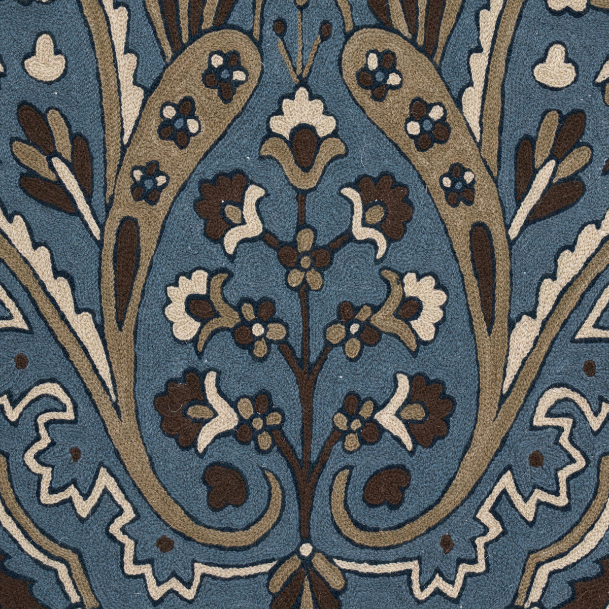 Indigo damask floral pattern on textile with brown, tan and white vines and blossoms.