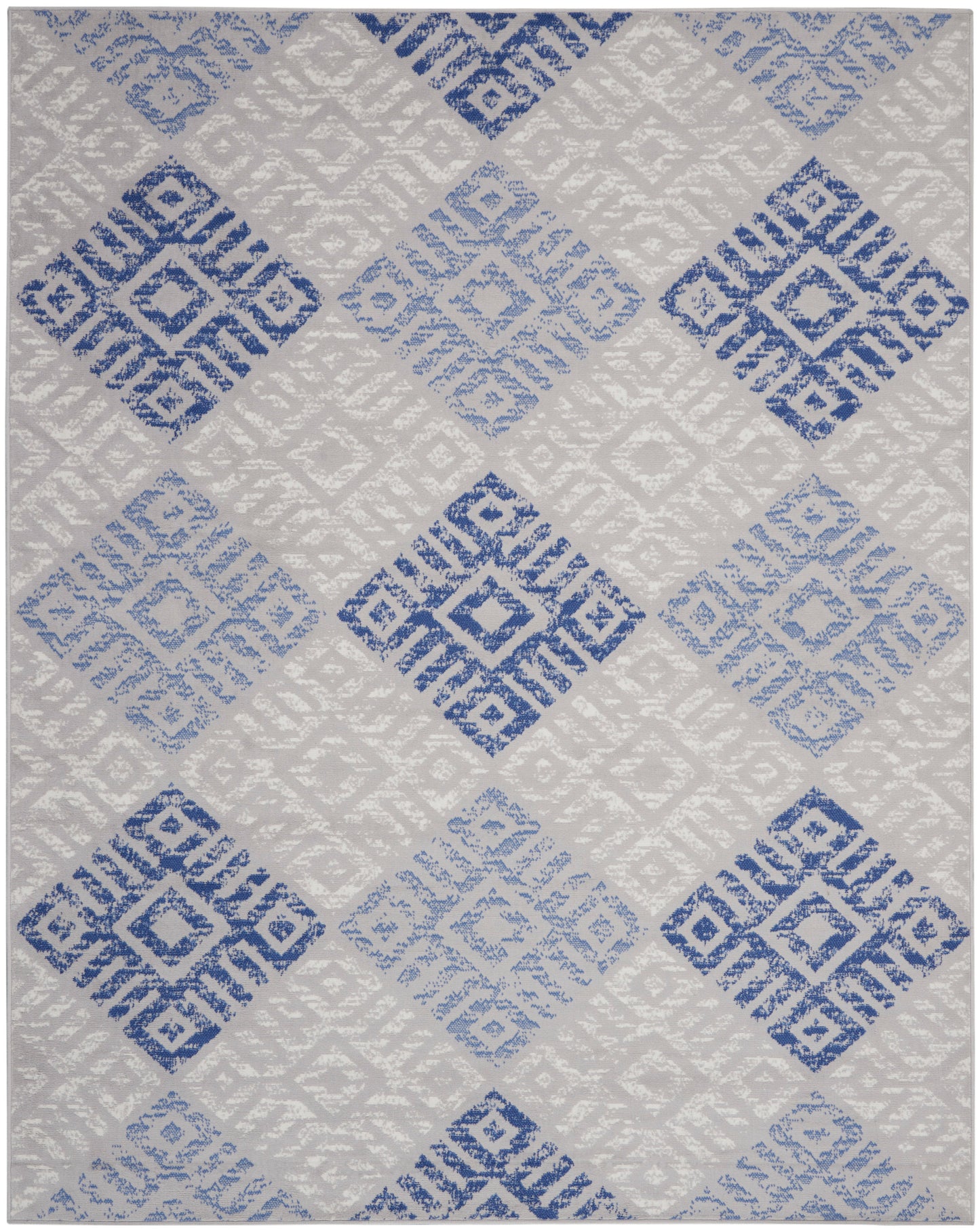 Geometric diamond-pattern rug in blue and gray tones; woven flat-weave, rectangular, modern contemporary living room accent.