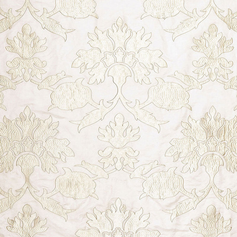 Beige damask floral pattern on cream fabric; ornate symmetrical scrolls and blossoms for upholstery or wallpaper.