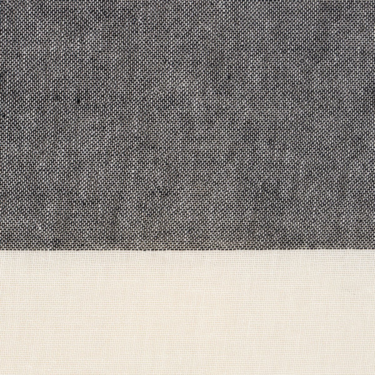 Two-tone woven fabric swatch: dark charcoal upper panel and light beige lower panel with fine texture.