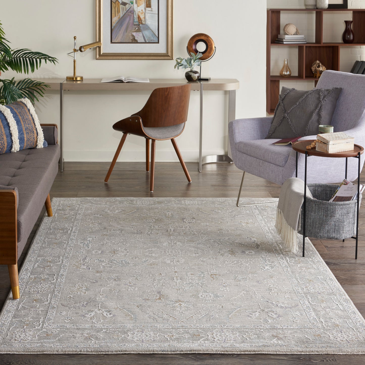 Neutral gray-beige oriental rug with floral medallion pattern on wood floor; mid-century sofa and chair in a cozy living room