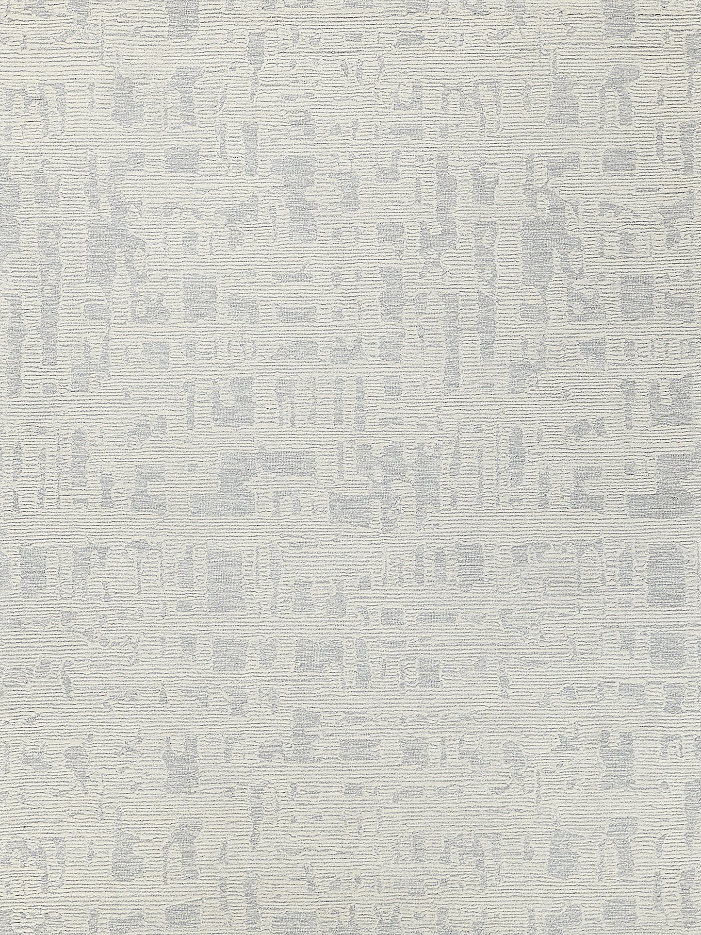 Hand-tufted rectangular rug in light gray tones with a subtle abstract pattern.