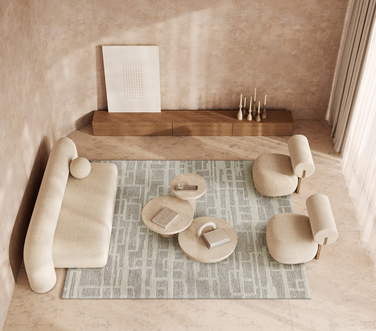 Indoor hand-tufted rug in pale blue with a patterned design, shown in a living room with a beige modular sofa & rounded ottomans & a wooden console with candles.