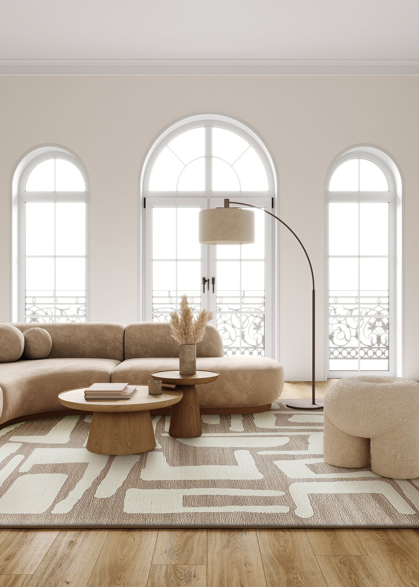 Neutral living room with arched windows, curved beige sofa and ottomans, wooden coffee tables, arched floor lamp, and a hand-tufted 6' x 9' rectangle rug.