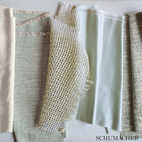 Row of fabric swatches in cream, beige, pale yellow mesh, light blue and gray knit; Schumacher label bottom right.