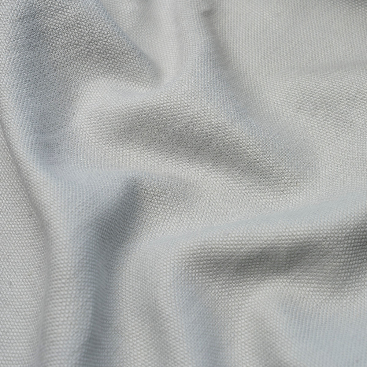 Light gray textured fabric with fine weave and soft drape; versatile for clothing or home textiles.