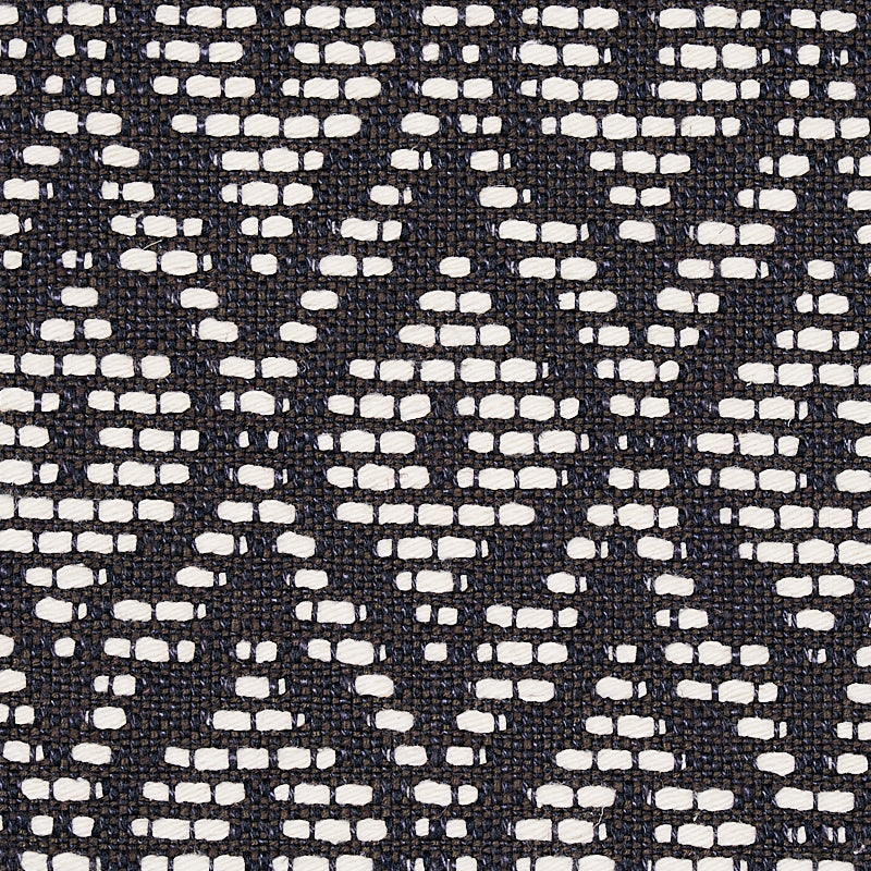 Charcoal upholstery fabric with a small-scale red hook pattern, woven texture.