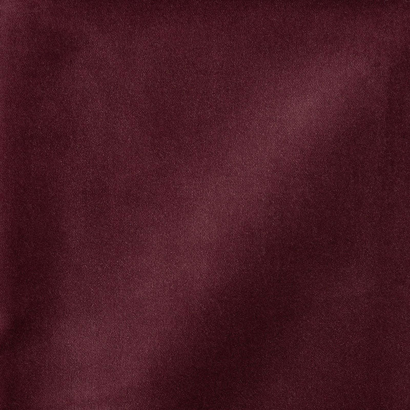Deep burgundy velvet fabric close-up with soft sheen and lush nap, luxurious upholstery or garment material.