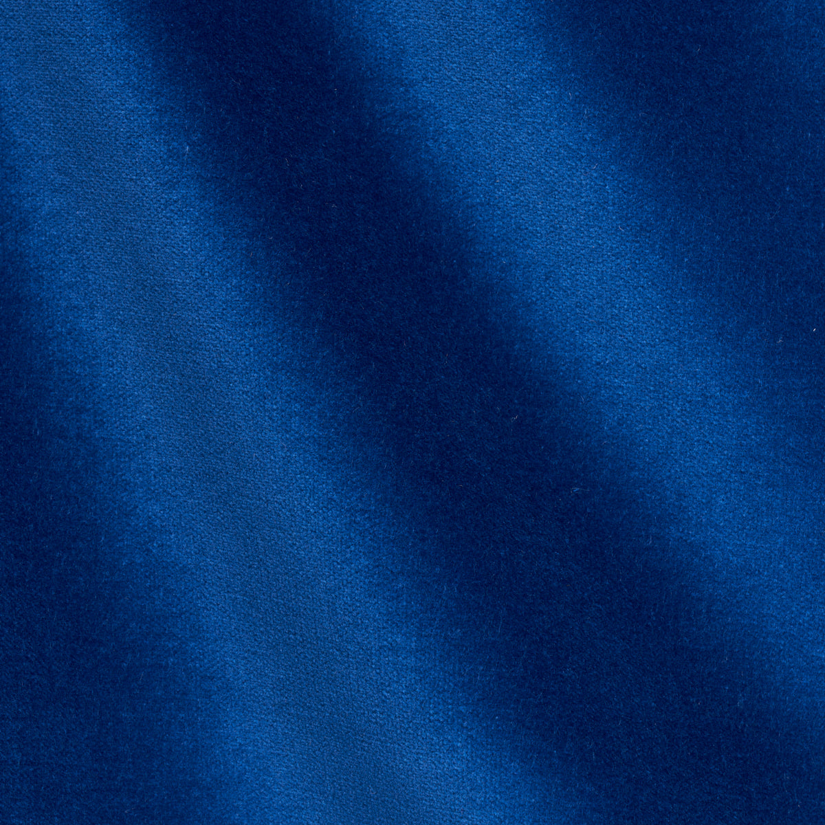 Royal blue velvet fabric close-up with soft folds and subtle sheen