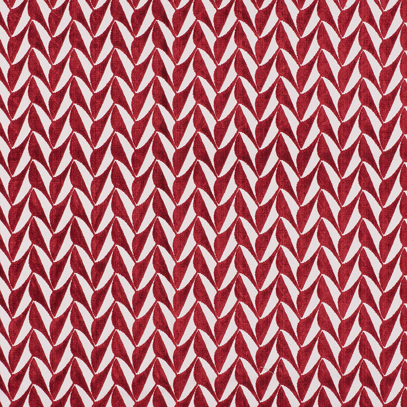 Red leaf-like chevron pattern on cream background; bold geometric textile print for upholstery or decor.