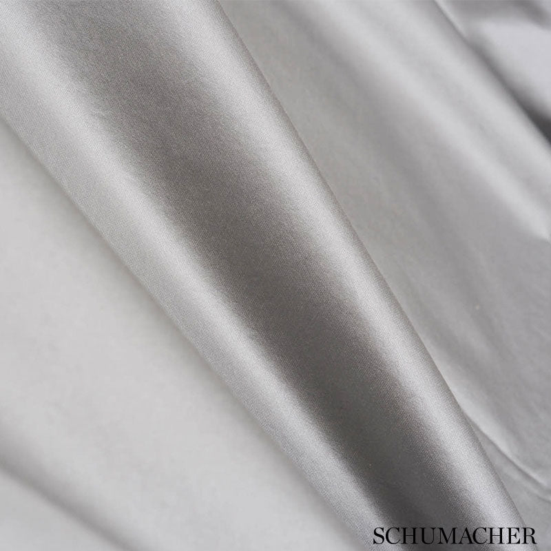Shiny silver satin fabric draped in smooth folds.