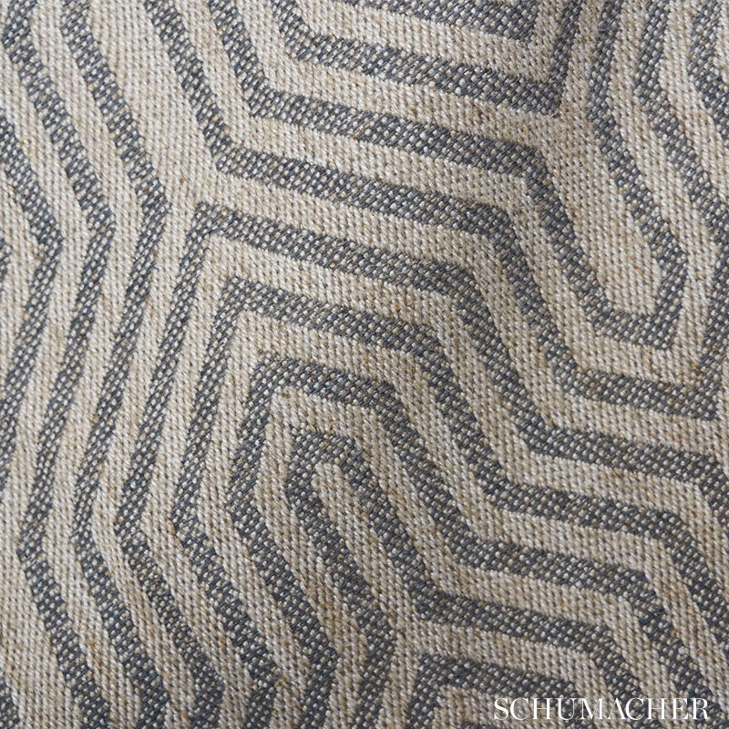 Beige and dark blue woven rug with a maze-like geometric pattern and textured surface.