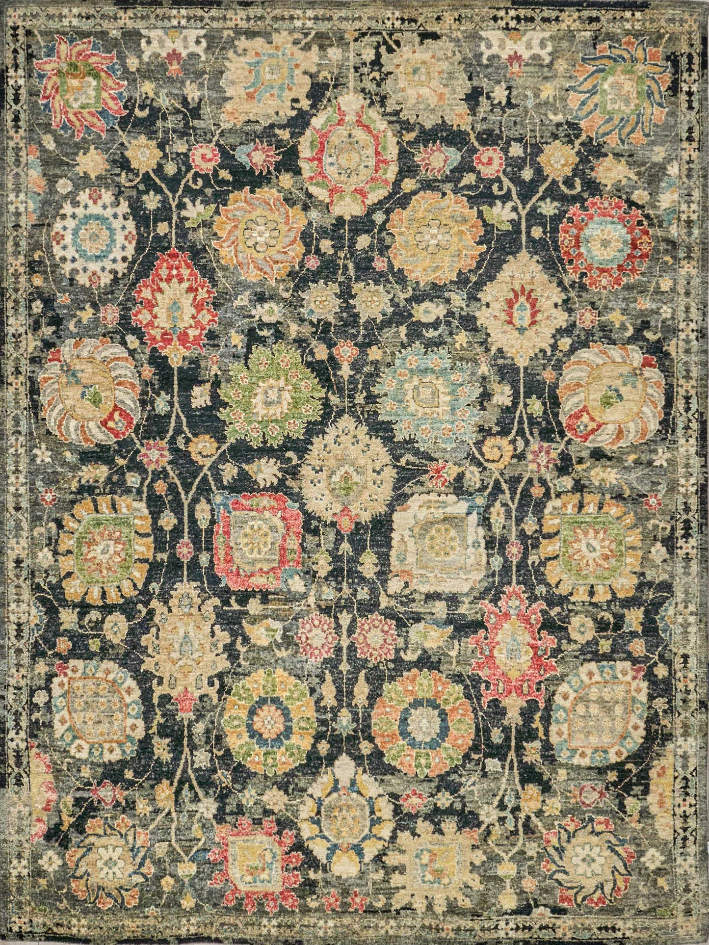 Indigo oriental rug with bright multicolor floral medallions and decorative border; vintage distressed look.
