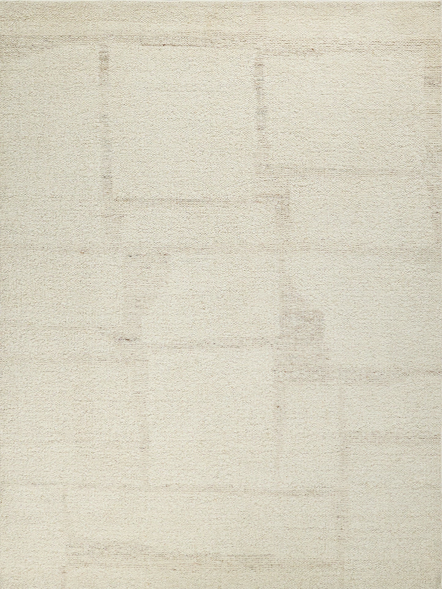 Cream-beige flat-weave rug with subtle rectangular patch patterns for neutral decor.
