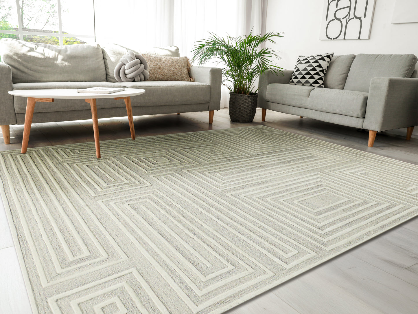 Neutral geometric area rug with layered rectangular maze pattern in light cream and gray; modern living room