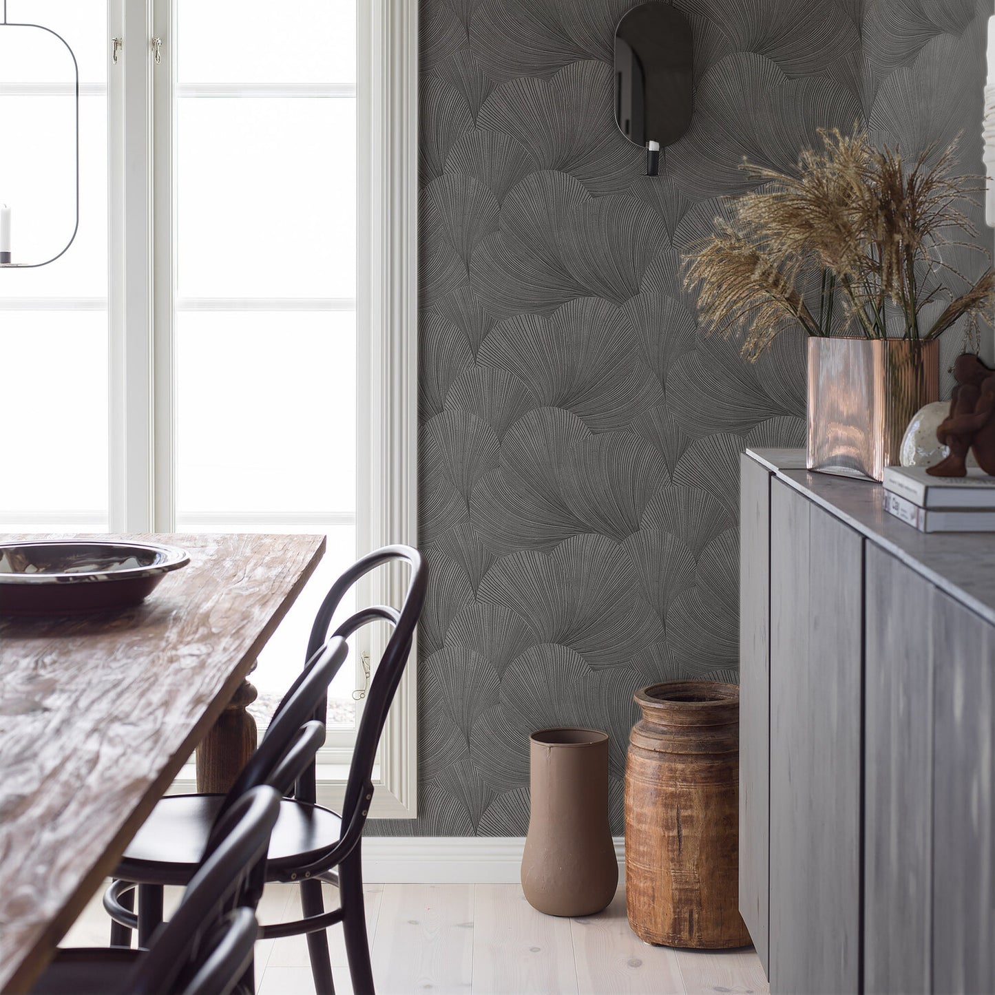 Charcoal leaf-pattern wallpaper on wall in a rustic dining room.