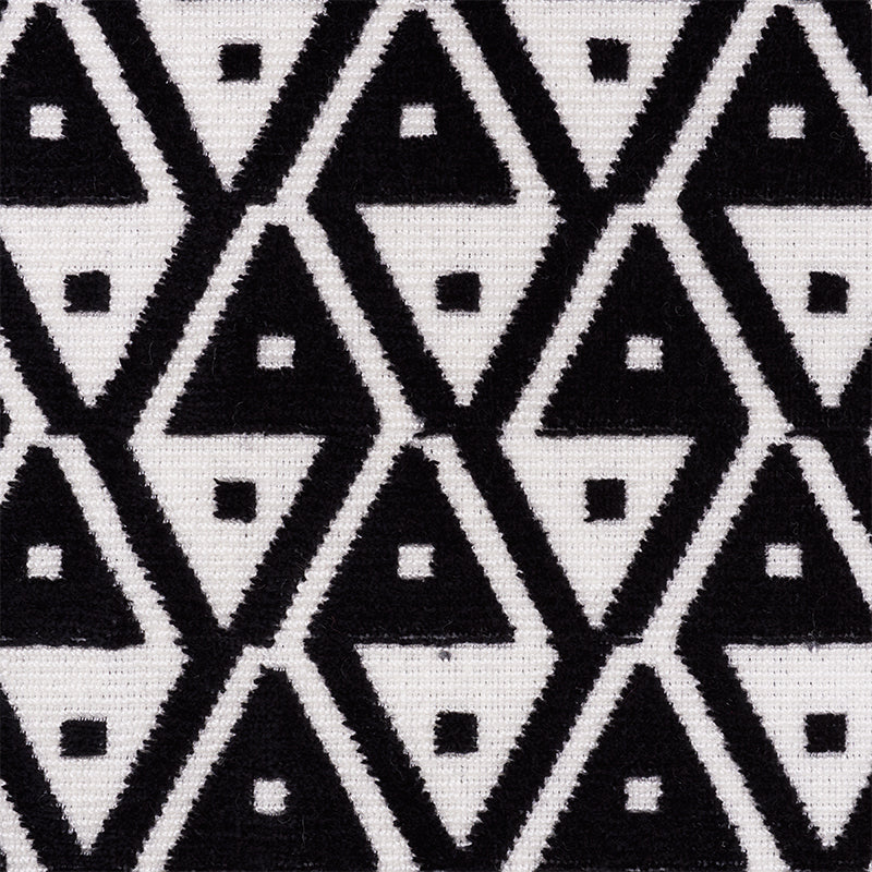 Black and white triangle tessellation on velvet; bold geometric pattern with tiny square accents.