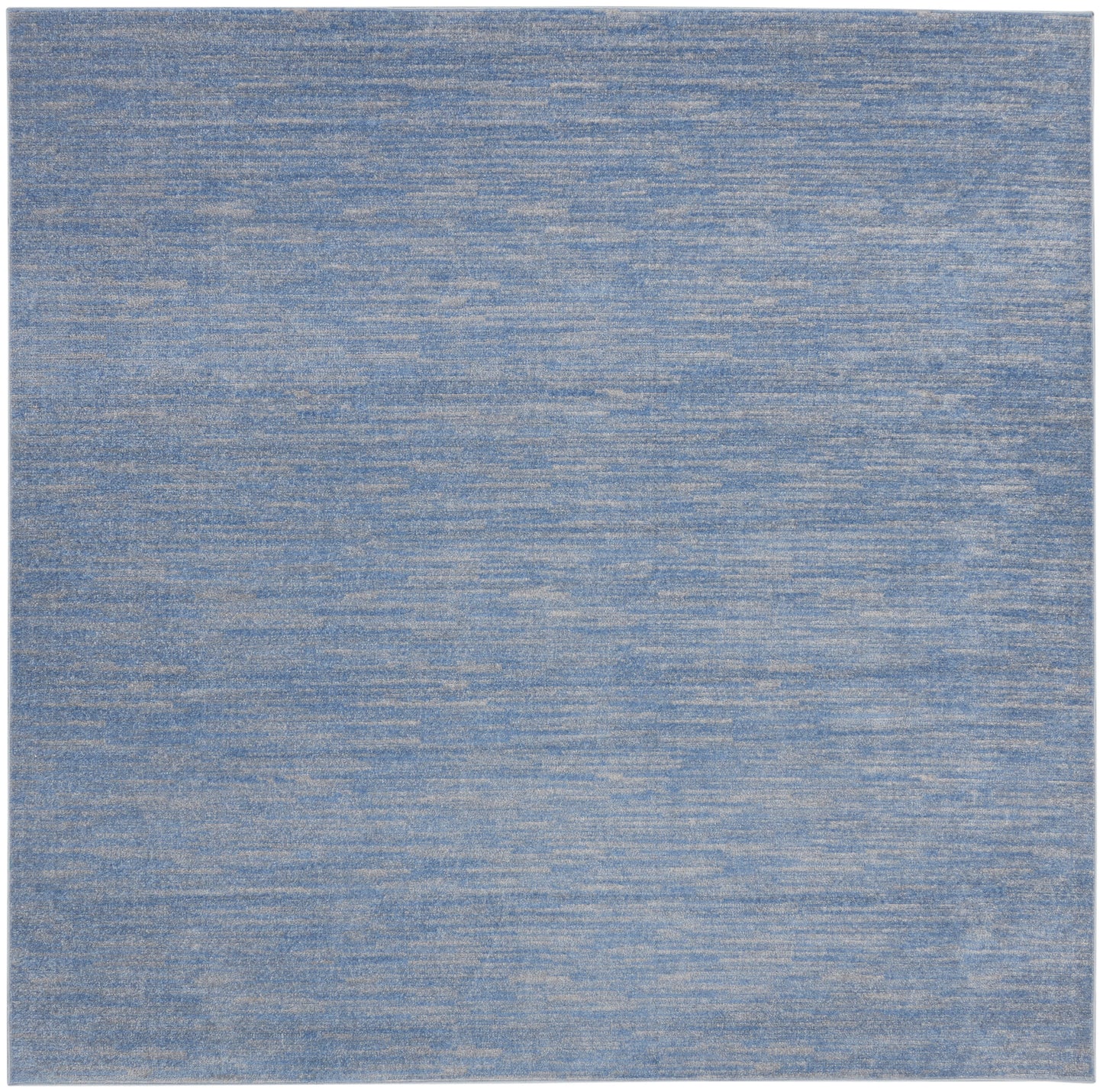 Blue heathered area rug with denim tones; rectangular, soft woven floor covering.