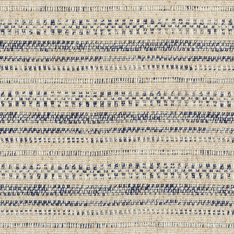 Beige woven rug with navy blue stripes and dotted motifs; natural-fiber, coastal rustic style.