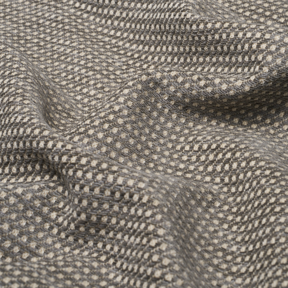 Grey tweed-like fabric with tiny beige dots, textured weave and soft drape.