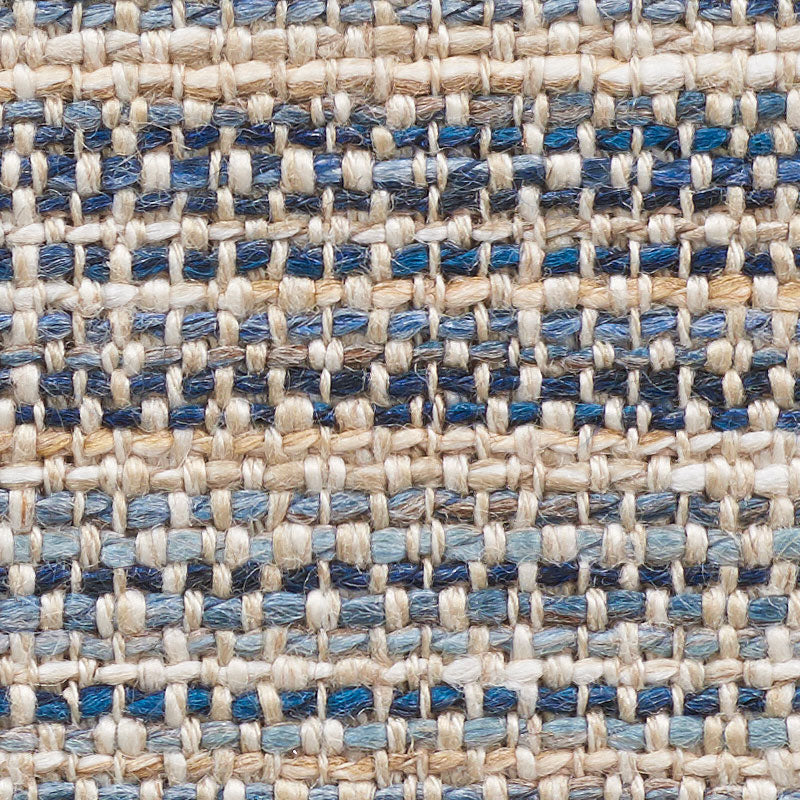 Close-up of beige and blue woven fabric with chunky fibers and a grid-like pattern.