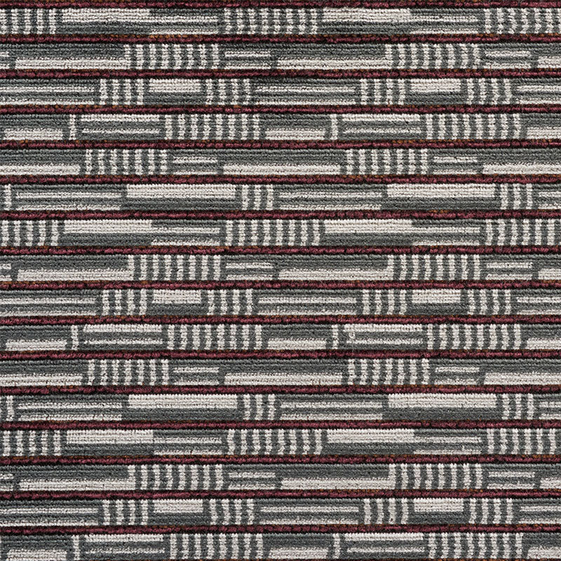 Geometric woven carpet tile in gray with maroon and white brick-like pattern, textured office hallway flooring.